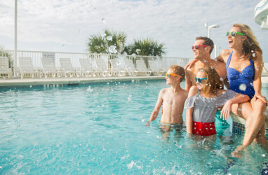 Family In The Oceanfront Pool